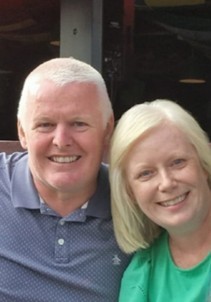 A man and woman sitting close together.