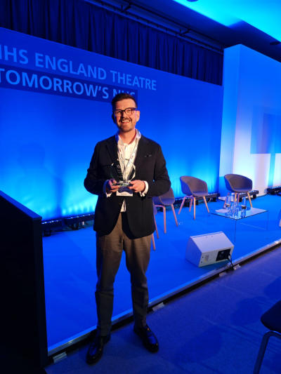 Paul Tinnion holding the award at the NHS Excellence Awards.png