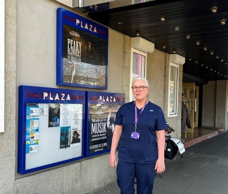 Paula McCann Finney, Nursing Team Leader from the Lung Cancer Screening service at Liverpool Heart and Chest Hospital, wearing her uniform, stood outside the Plaza Cinema.